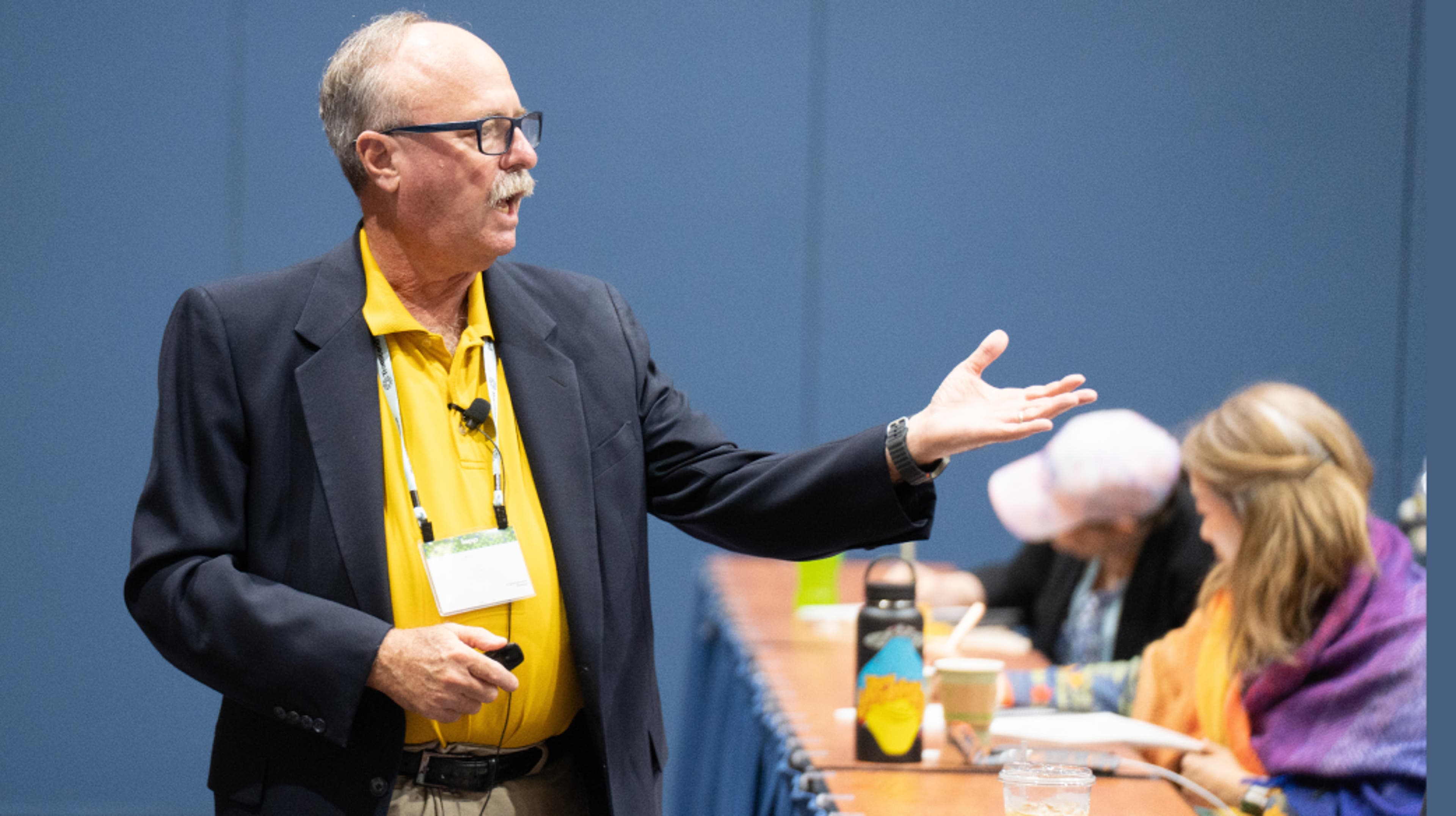 woman raising hand in live-taught class