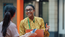two women engaged in conversation while standing