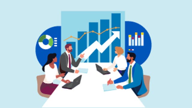 Four people at a table with laptops discussing in front of a large upward-trending chart.