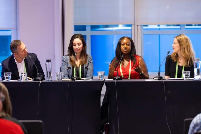 Two women at a panel presentation at a conference
