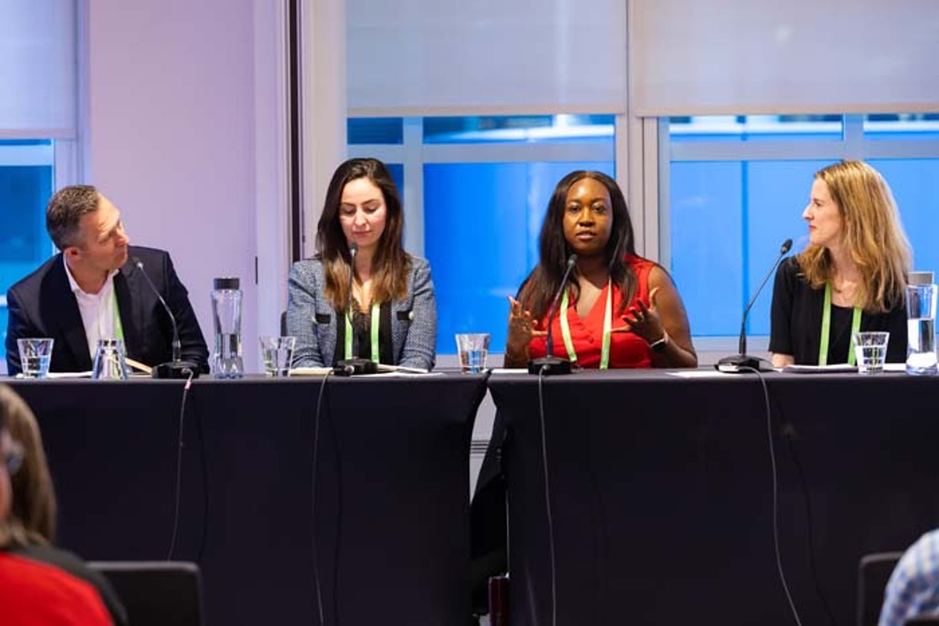 Two women at a panel presentation at a conference