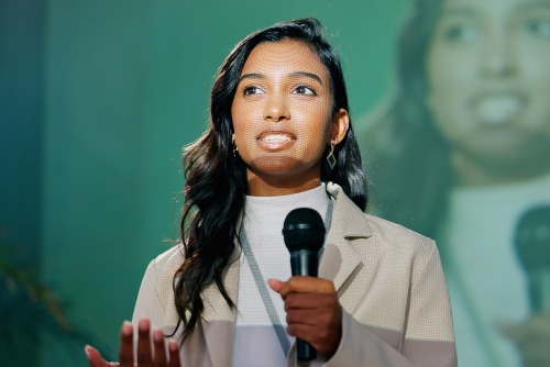A woman holding a microphone and speaking