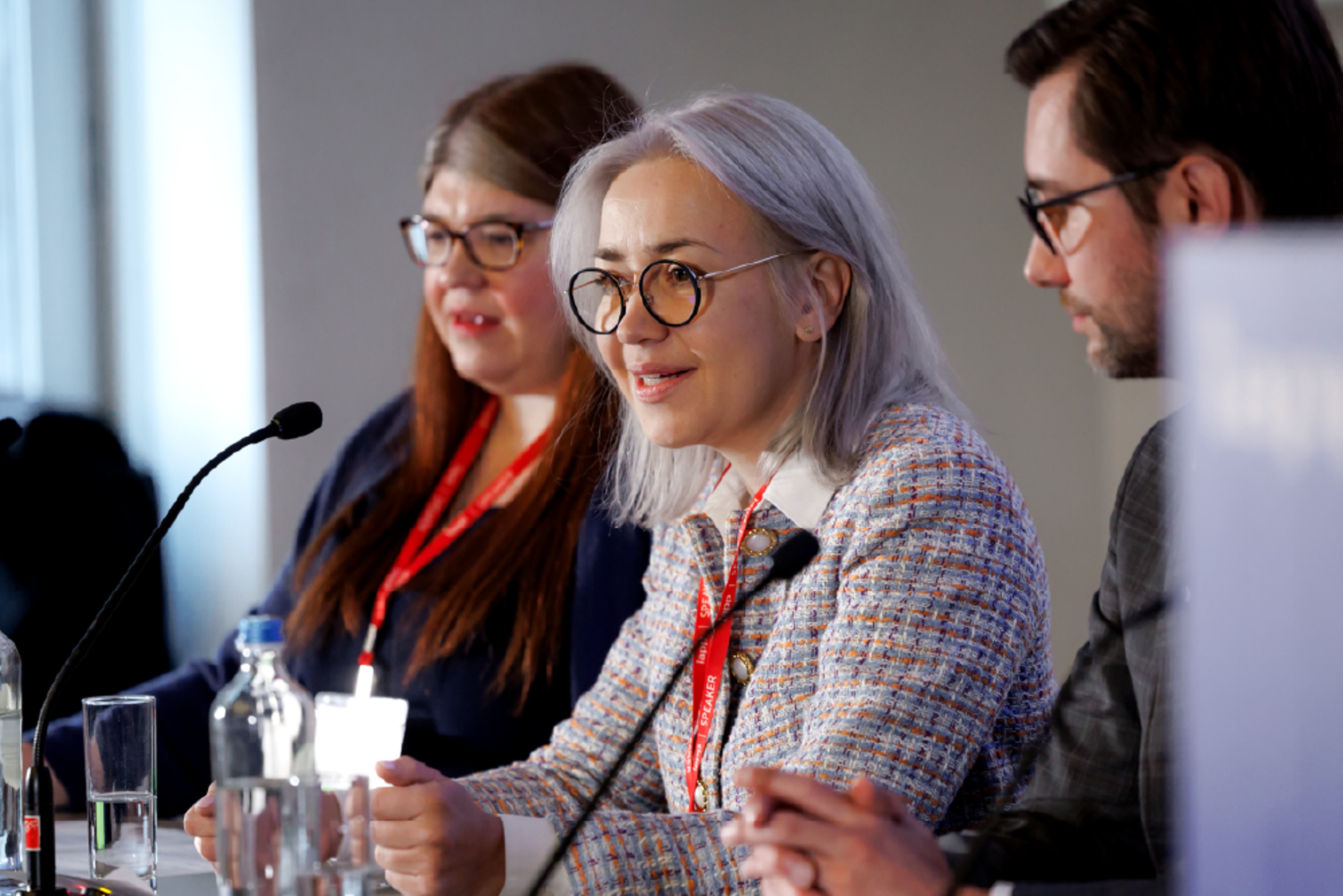 A woman holding a microphone and speaking