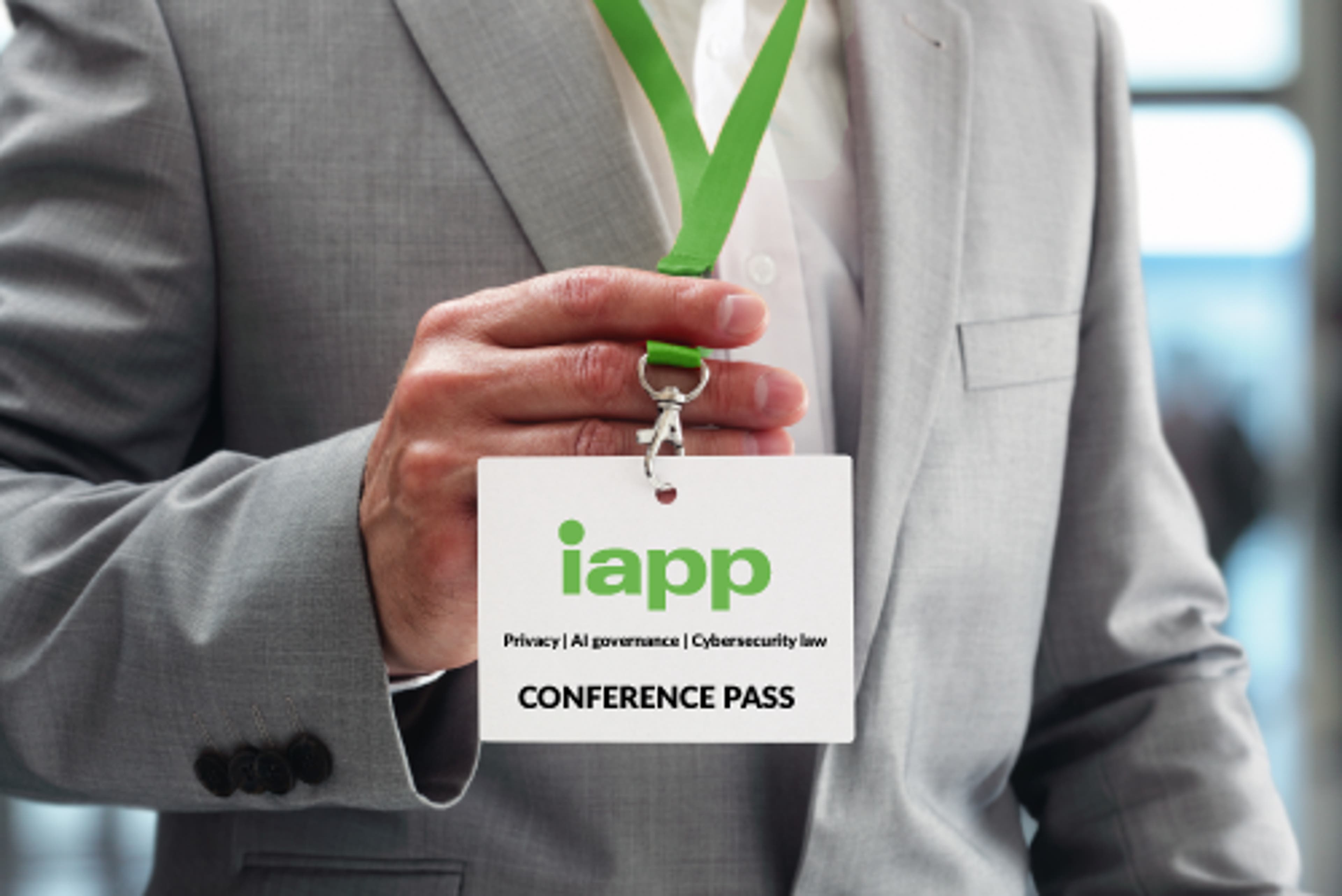 A person holding an IAPP conference badge
