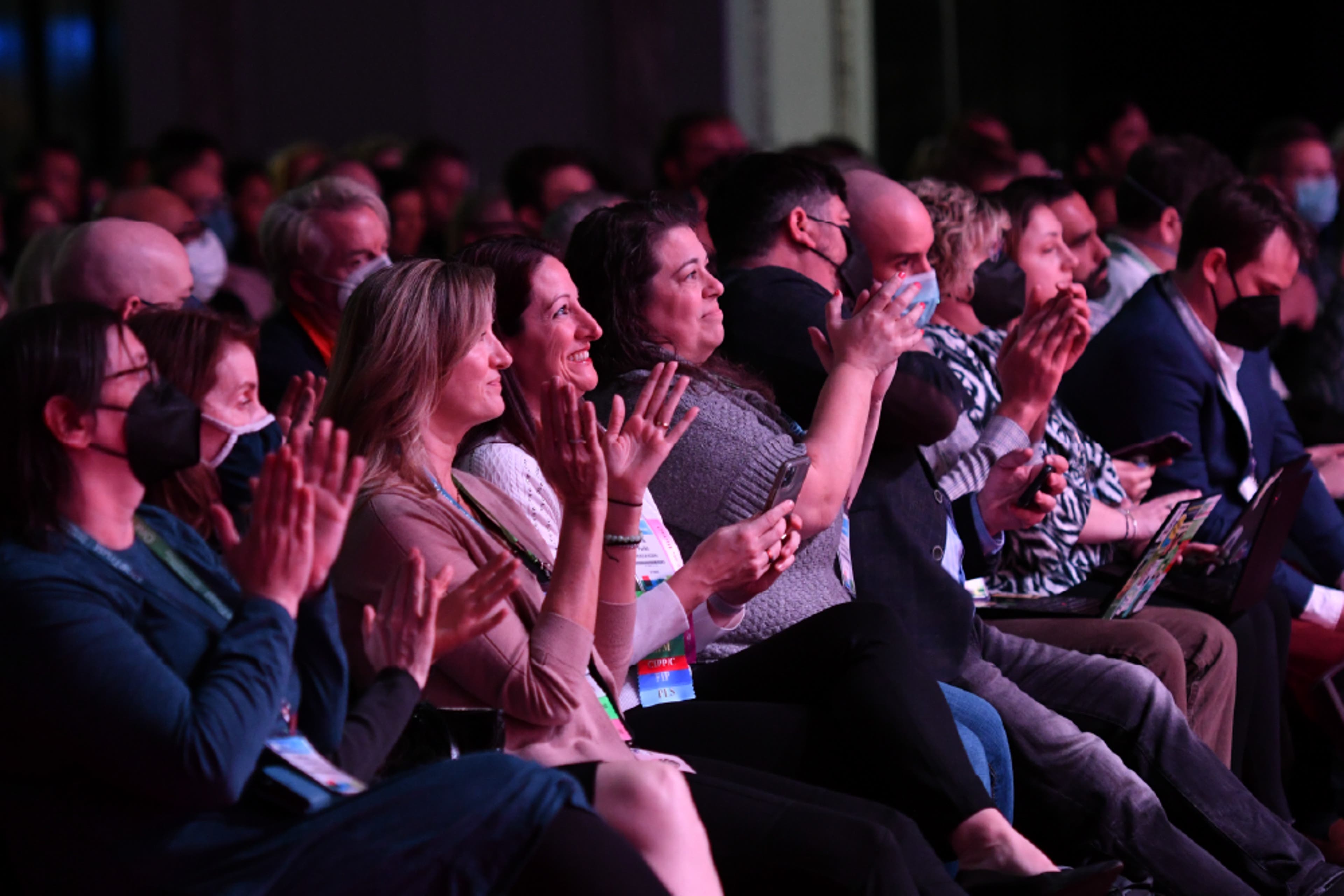 A person holding an IAPP conference badge
