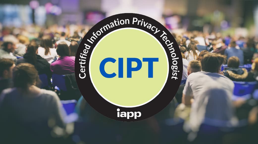 Large black and light yellow circular badge with the text “Certified Information Privacy Technologist” around the edge and “CIPT” in bold letters at the center, along with the IAPP logo. The badge is overlaid on a blurred background of a crowded conference audience seated in rows.