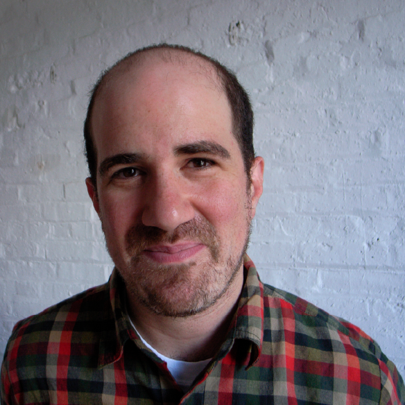 Artist Zach Lieberman. He is looking at the camera and smiling and wearing a flannel shirt.