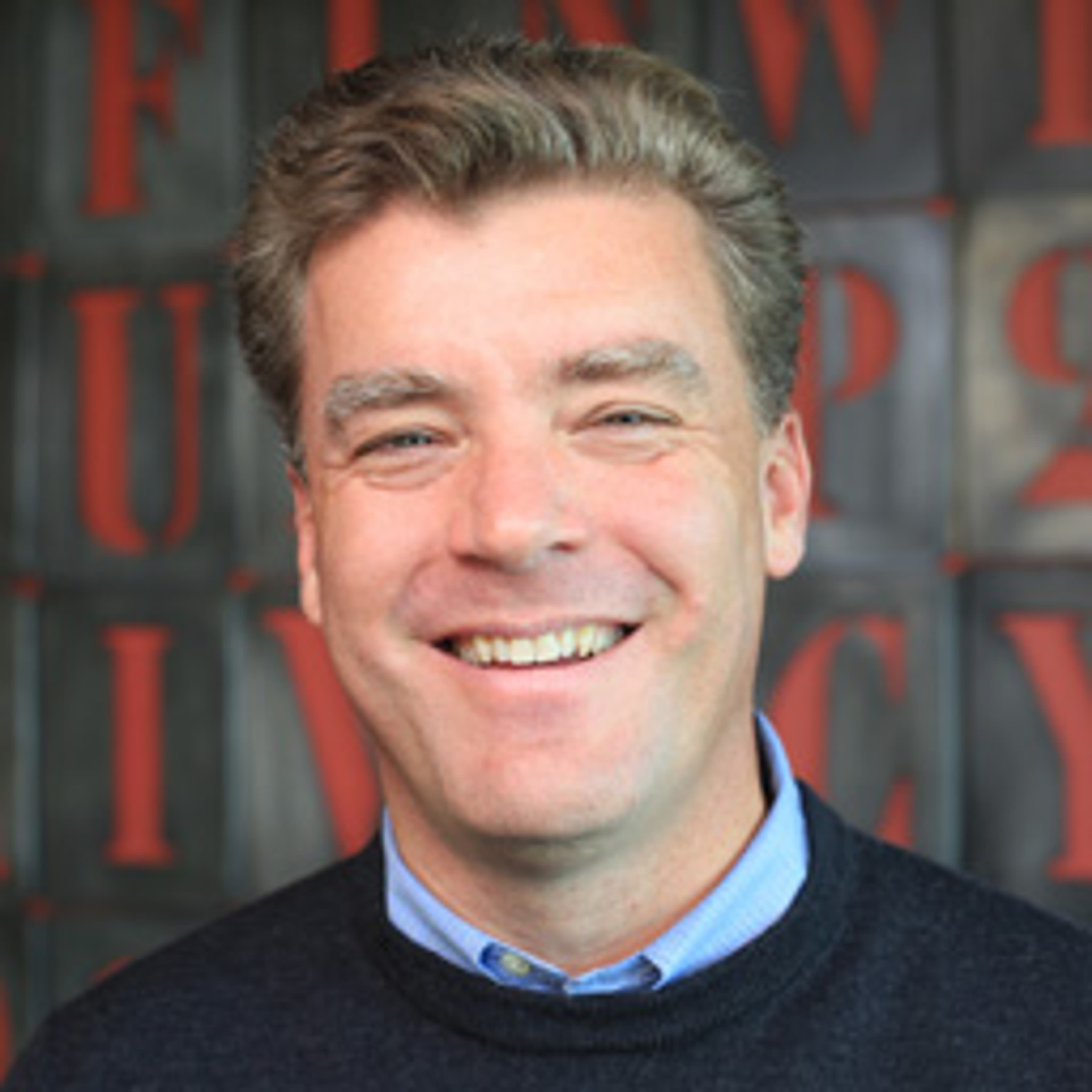 headshot of J. Trevor Hughes