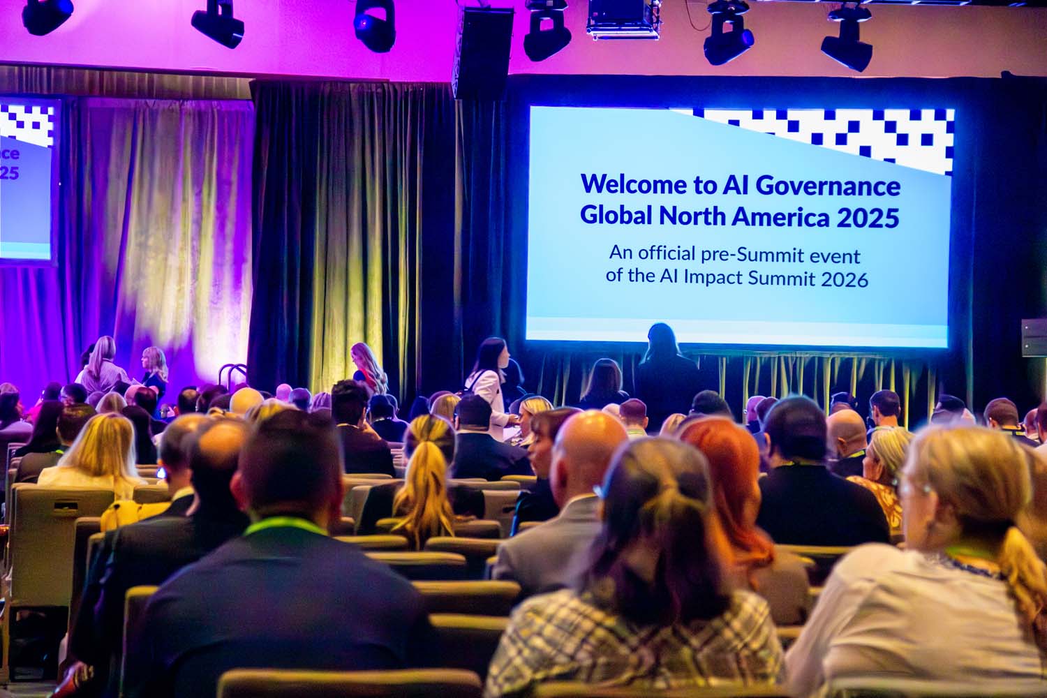 Rows of attendees fill a large ballroom, all facing a bright screen that reads “Welcome to AI Governance Global North America 2025,” creating an anticipatory atmosphere before a major session begins.