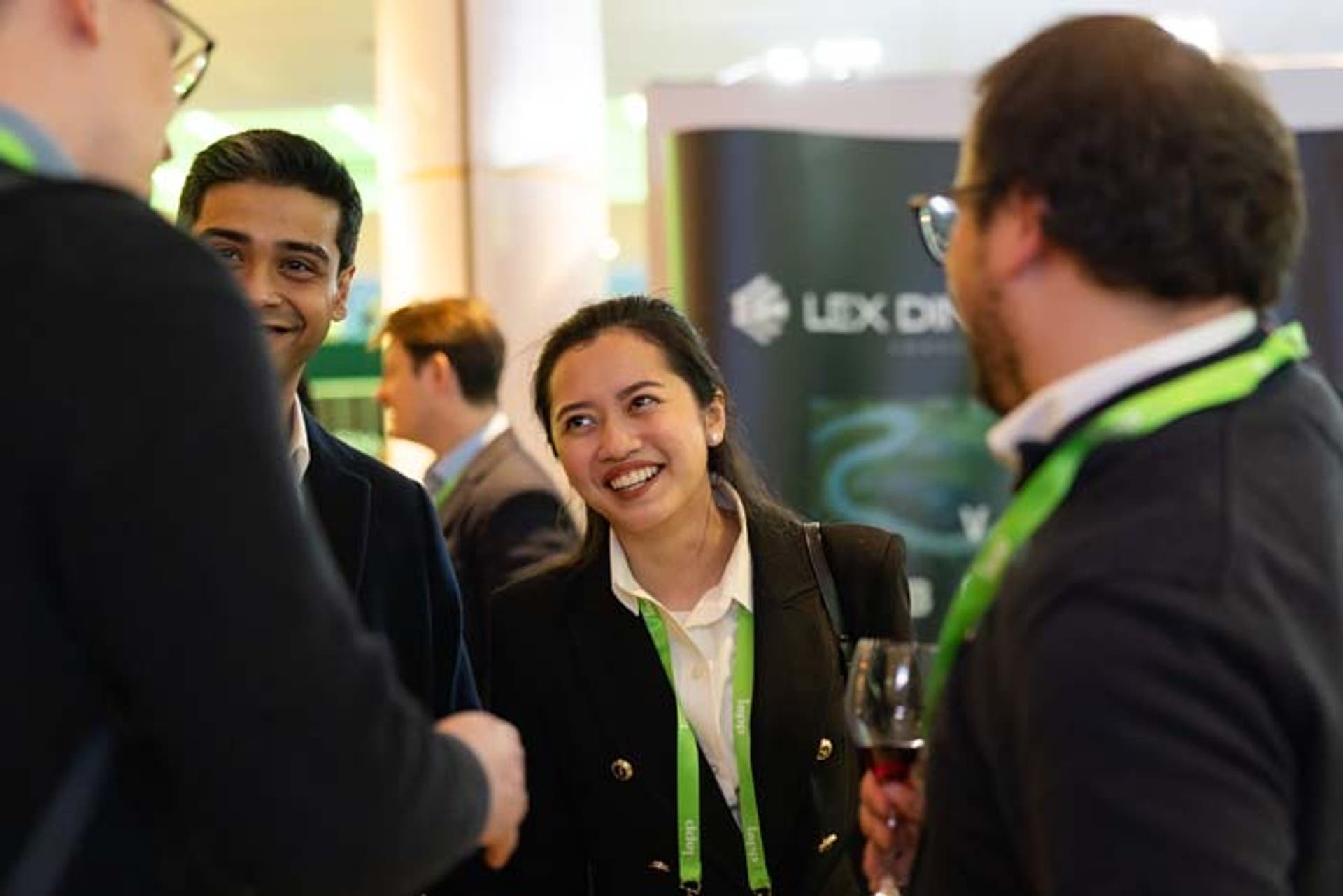 A group of people having a conversation at a conference