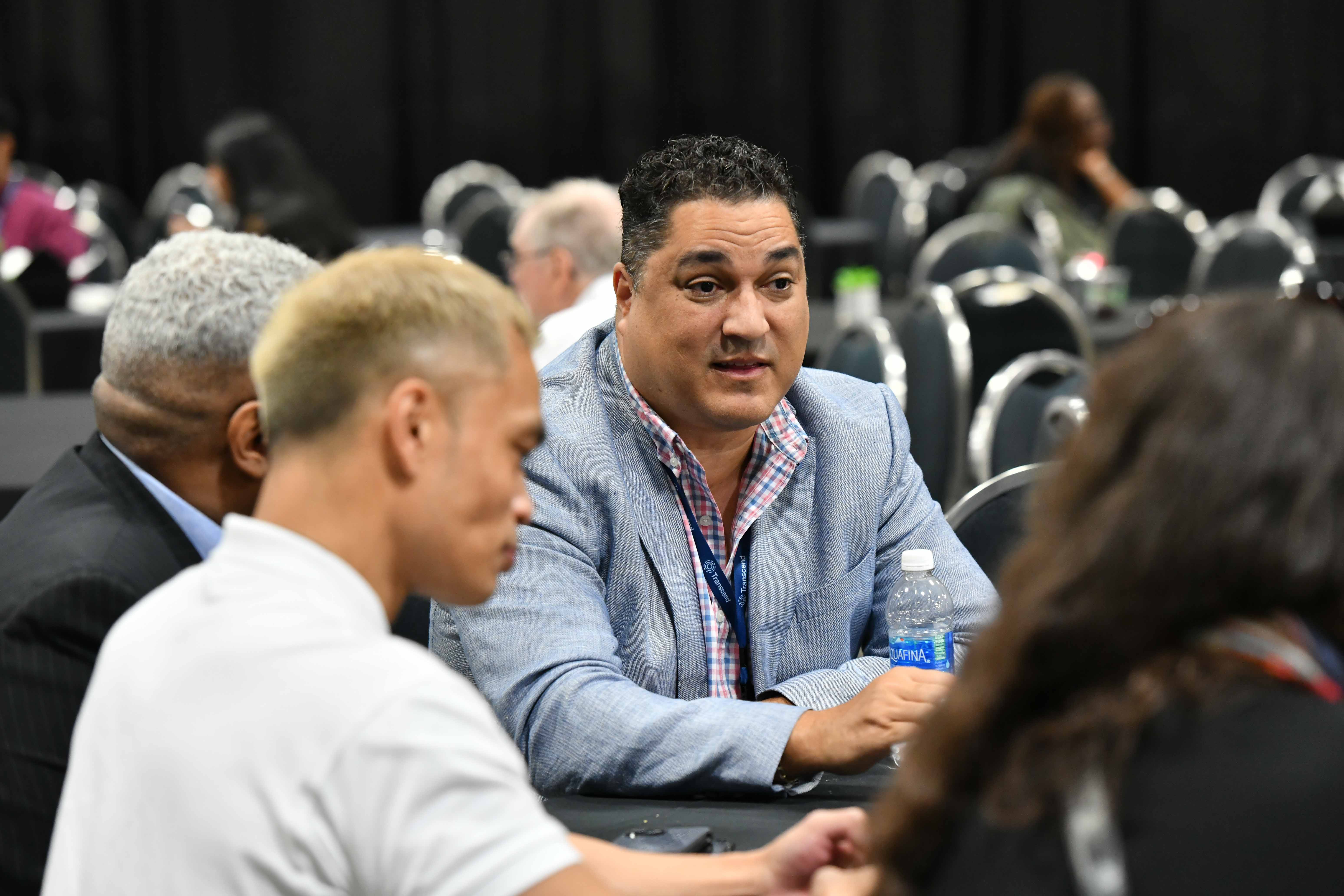 Three people talking at a Diversity in Privacy section meetup
