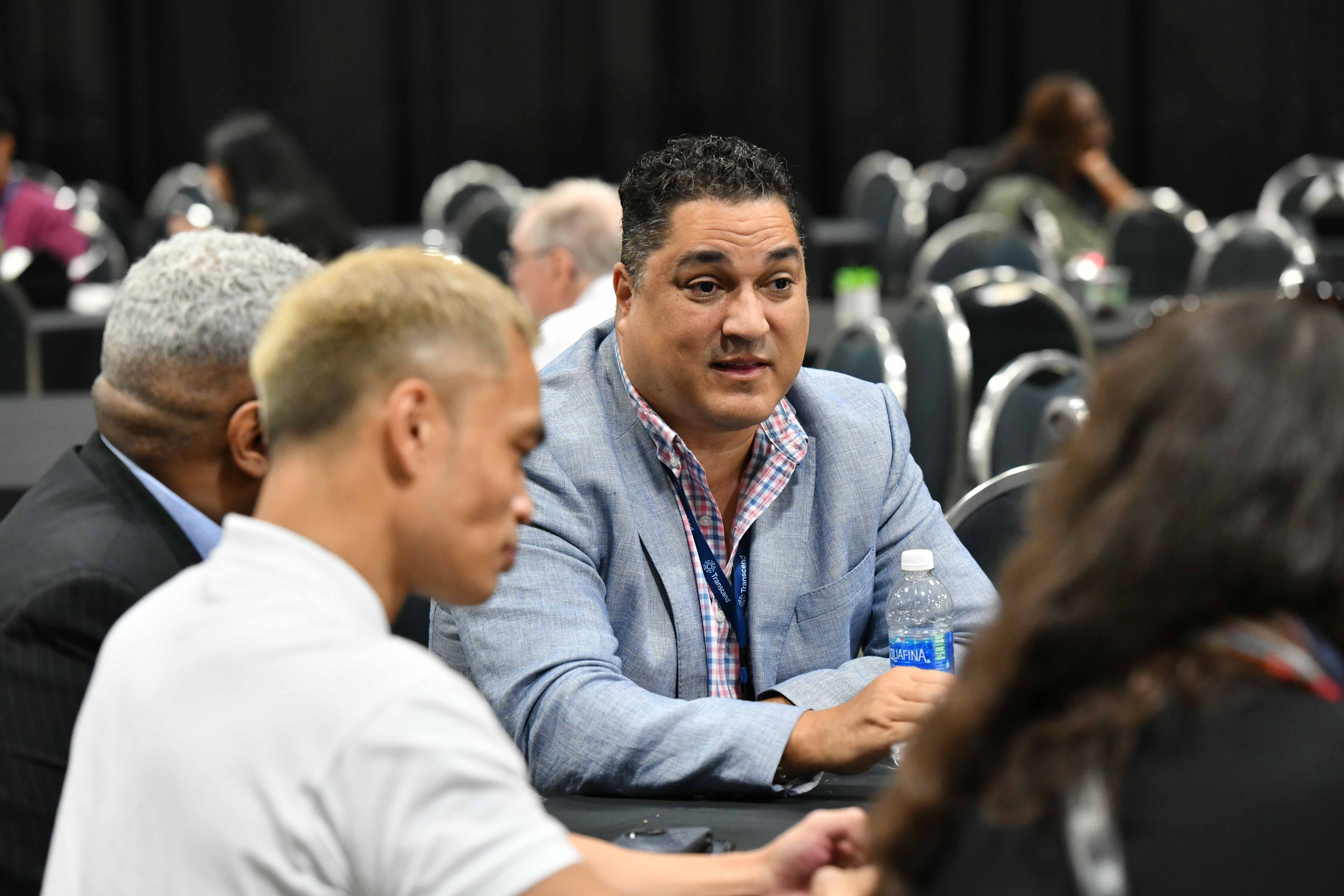 Three people talking at a Diversity in Privacy section meetup