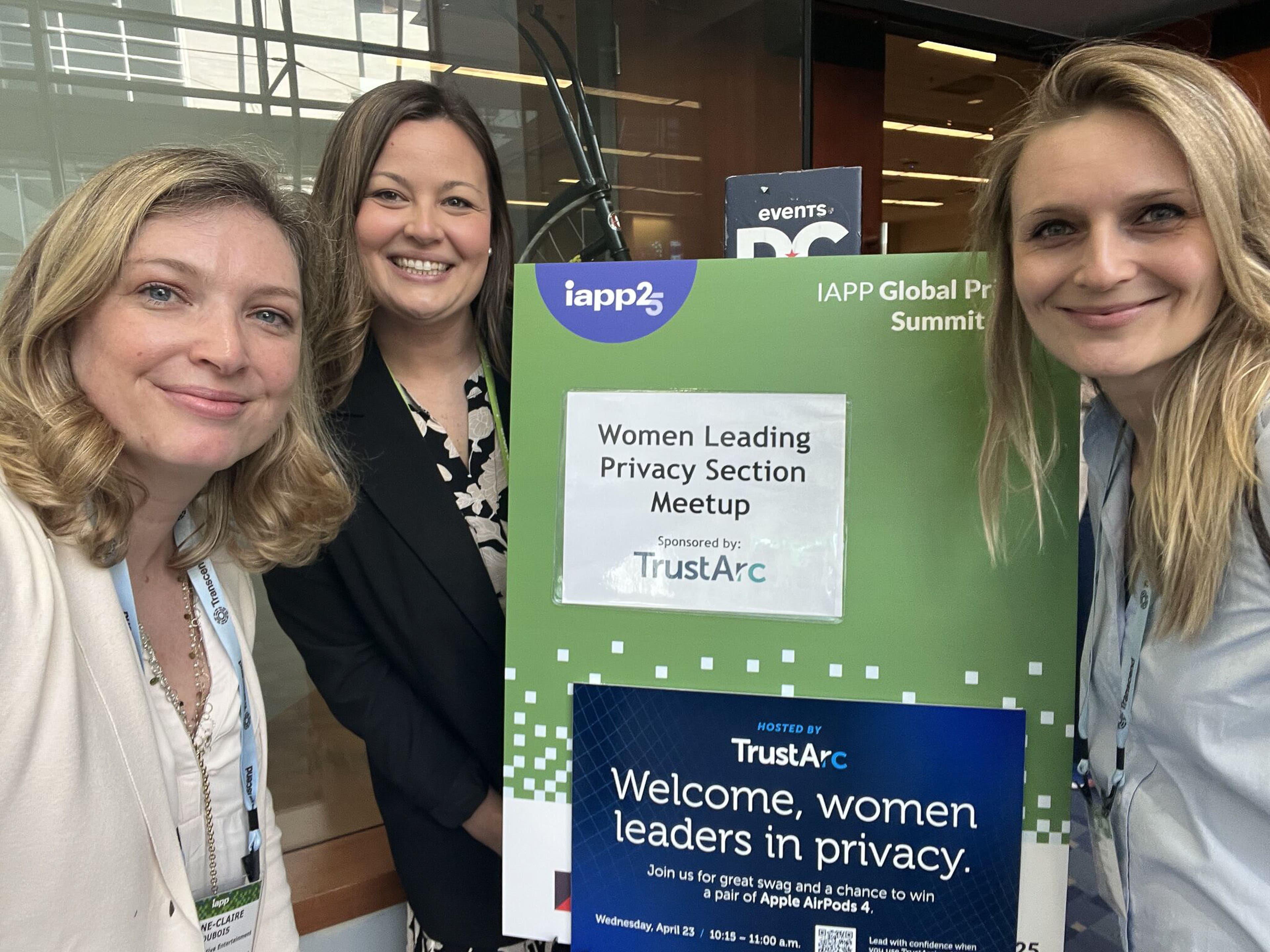 A group of women posing in front of a Women Leading Privacy section meetup sign
