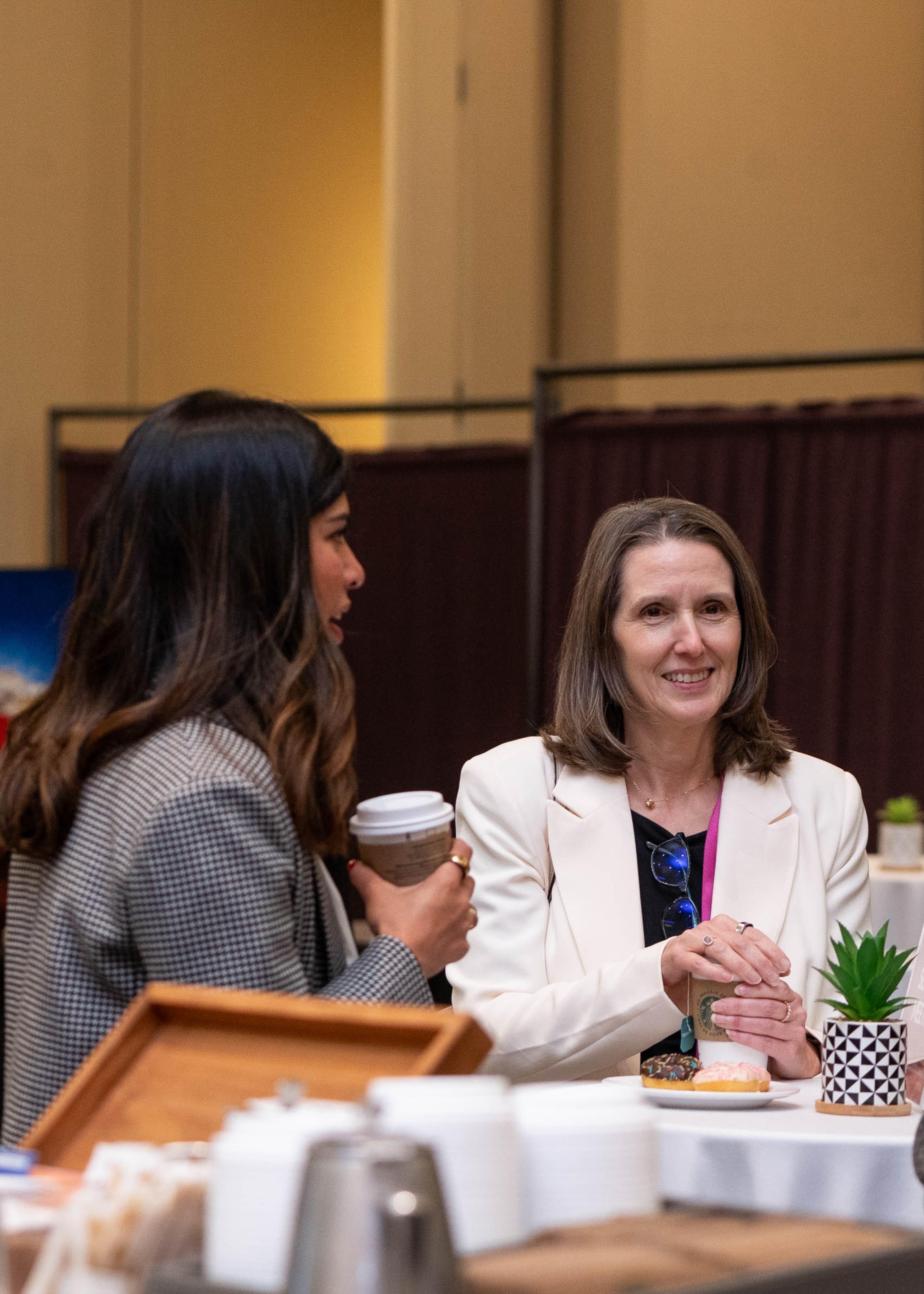 Two women speaking to each other at a Diversity in Privacy section meetup