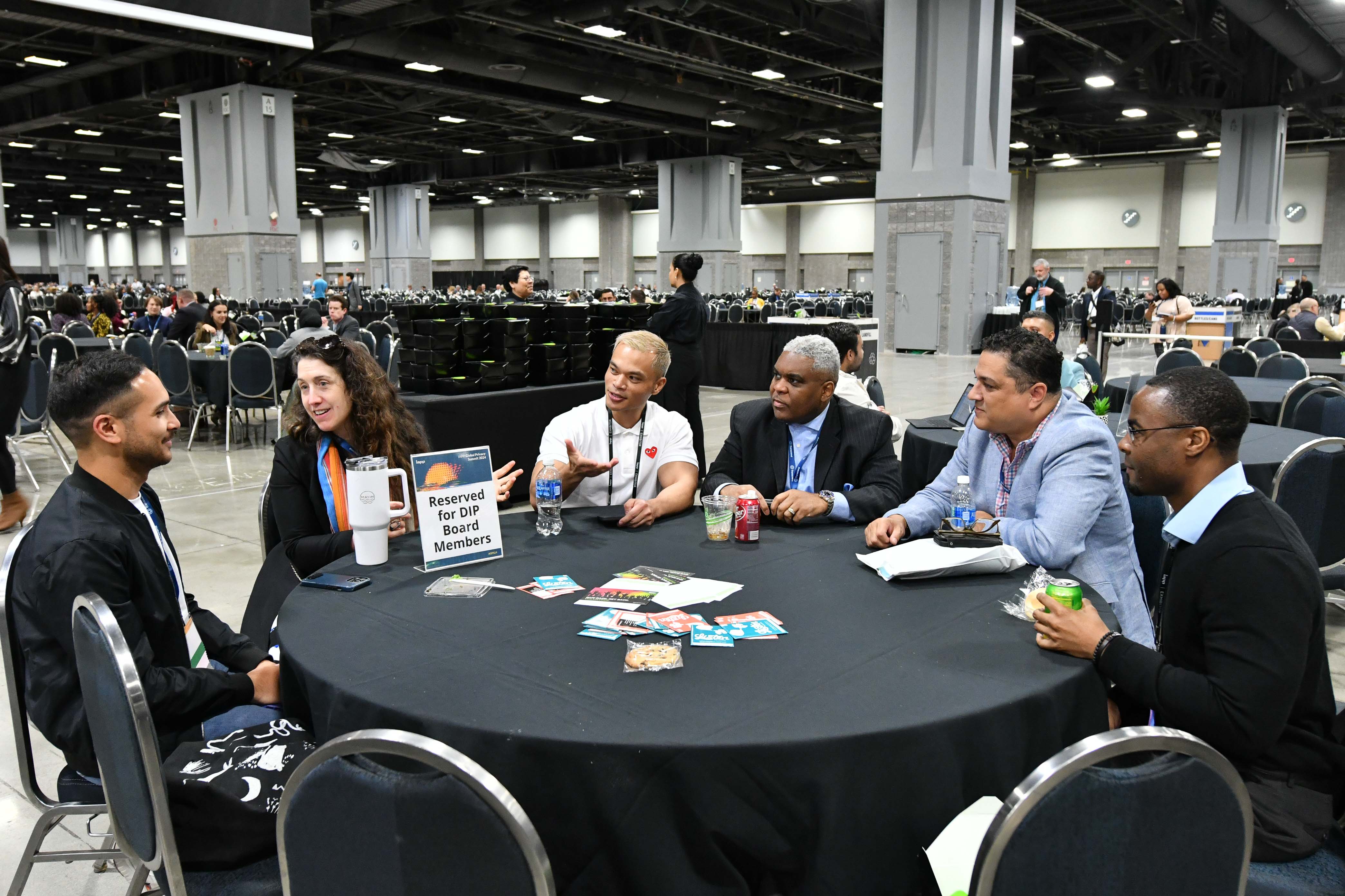 A group of people sitting around a table at a Diversity in Privacy section meetup