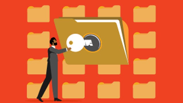 Person holding a large key to unlock a folder among rows of folders on an orange background.