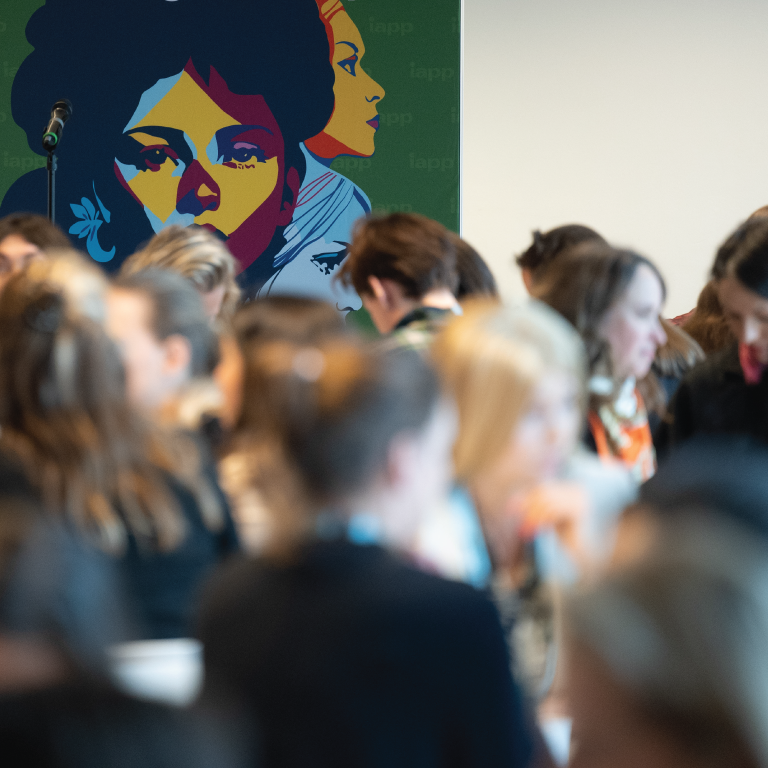 Group of people standing in front of a mural