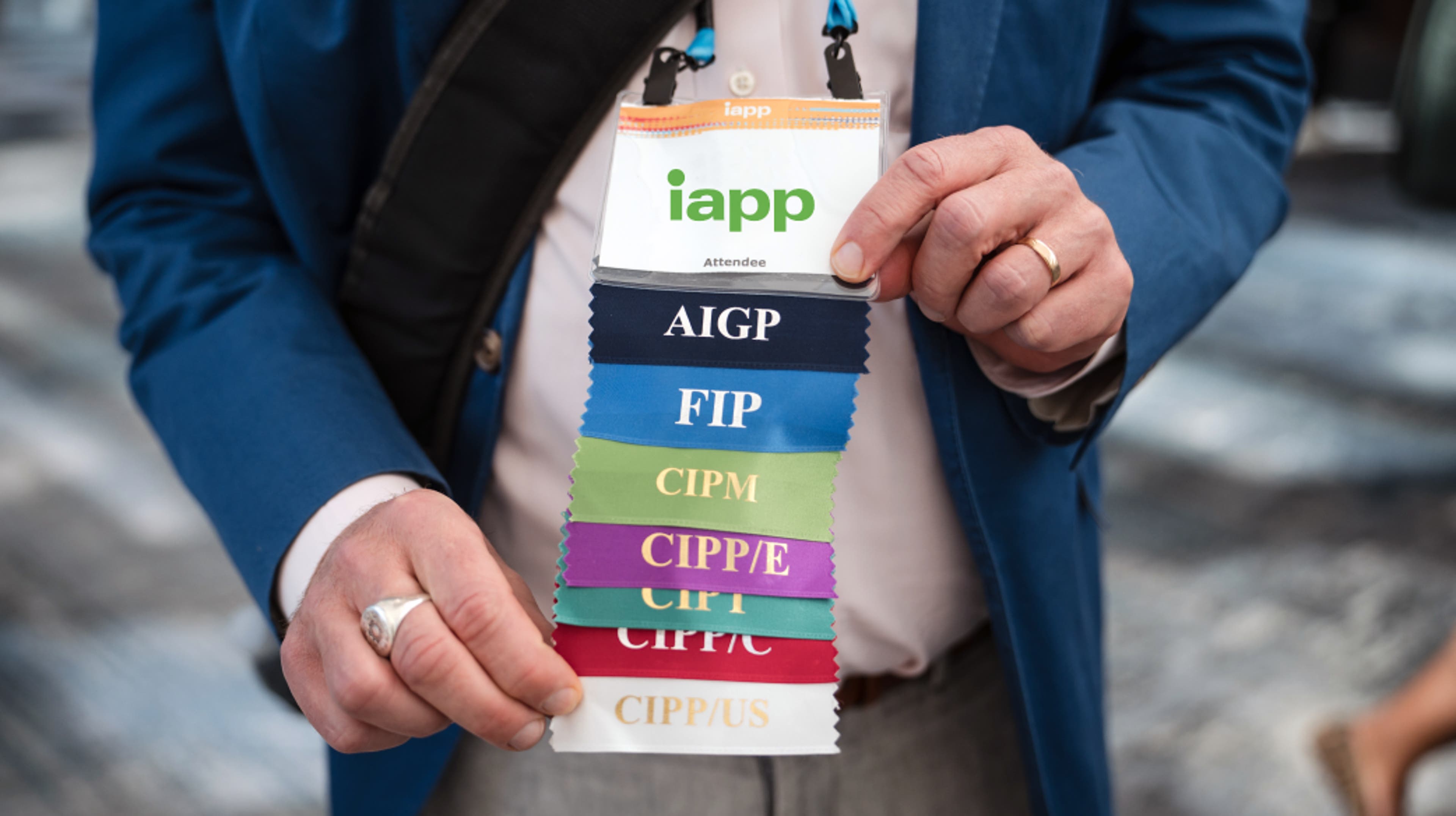 Person in background with their hand in foreground holding a FIP designation card