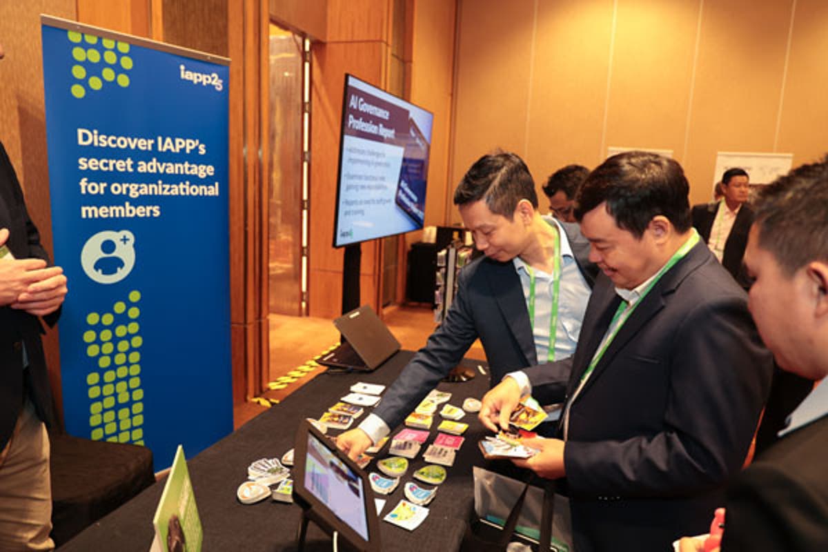 Speaker at a podium with signage reading “IAPP Asia 2025: Privacy Forum + AI Governance Global.” A large red screen beside the podium displays event branding and hashtag #APF25.