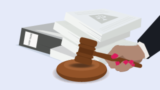 Hand holding a gavel next to a stack of legal documents and a binder labeled "Case Law."