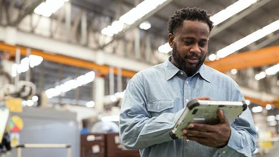 supply_chain_visibility_hero.jpg A man using a device to track materials, components and goods.