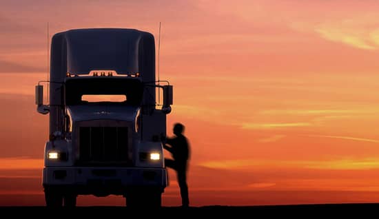 chameleon carriers_jul2026_hero.jpg Silhouette of a person stepping into a semi-truck at sunset