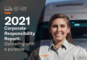 Picture of a female truck driver in front of a truck.