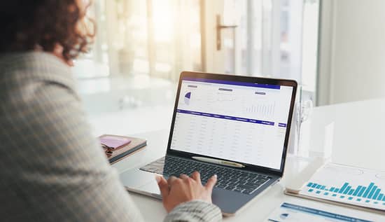 A shipper reviewing financial metrics on a laptop in the form of charts, graphs and tables.