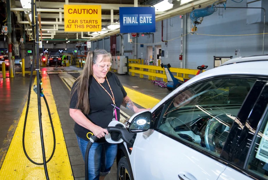 woman charging an electric vehicle.