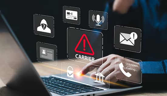 face of freight fraud_aug2026_hero.jpg person's hand using a laptop with multiple icons hovering above within boxes representing cargo security practices