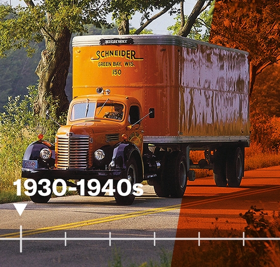 Early model orange Schneider truck on the road in the 1930s