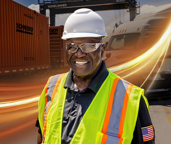 Intermodal driver standing in front of Schneider intermodal container and Schneider tractor