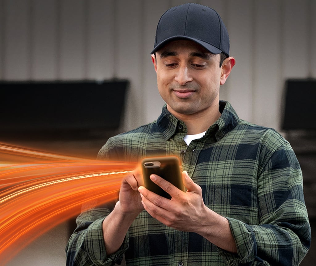 Person holding cellphone reviewing load board options