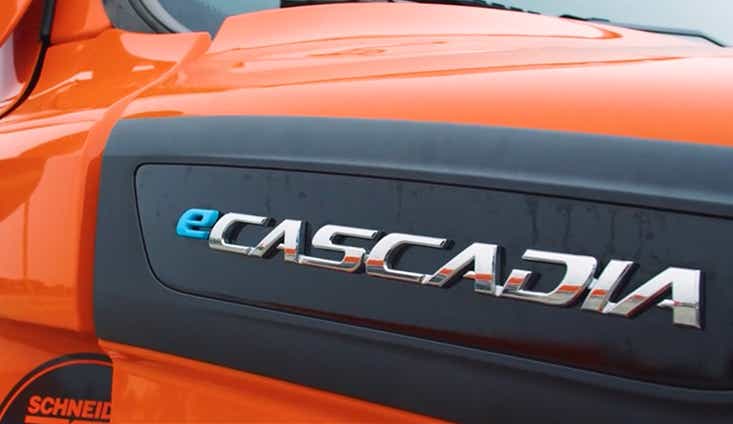 A close-up of the eCascadia emblem on Schneider Intermodal battery-electric truck