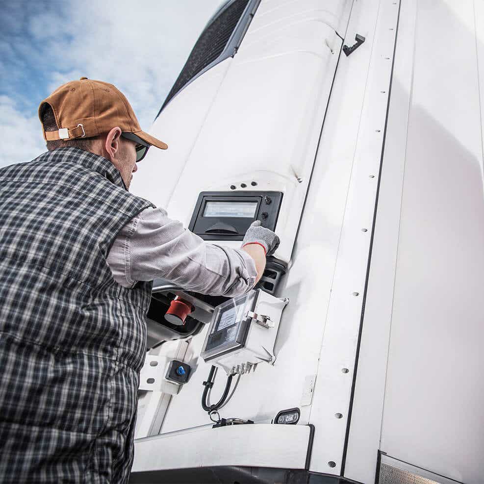 driver setting the temperature on a reefer truck for delivery