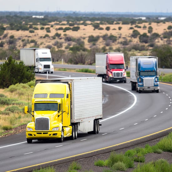 Four semi-trucks on a curved road