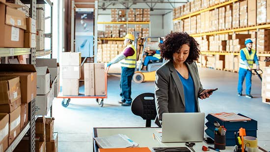 An LTL shipping expert using a computer in a warehouse