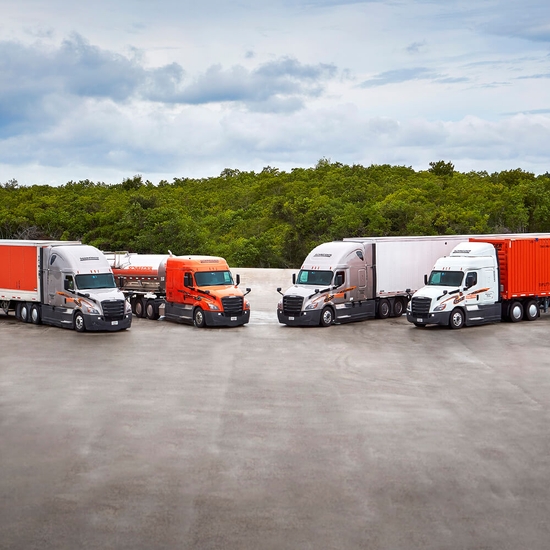 four Schneider trucks parked in a row representing multimodal modes