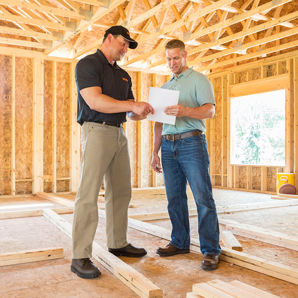 men reviewing paperwork at a construction site