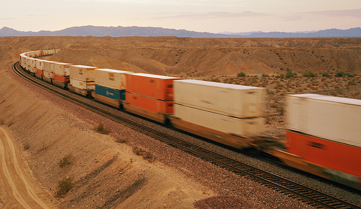 A freight train curving through a desert