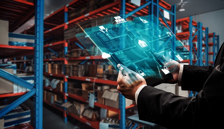 Person standing in warehouse with tablet in hand