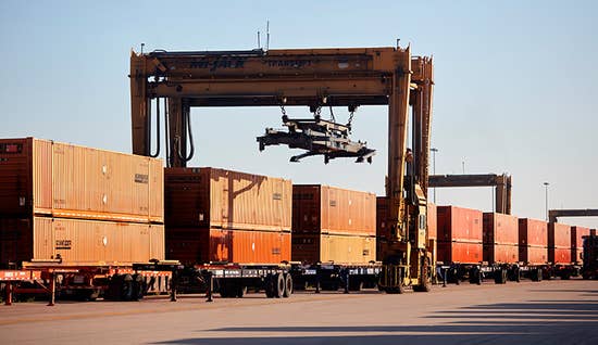 cargo theft-intermodal-containers.jpg train of intermodal trailers at loading dock