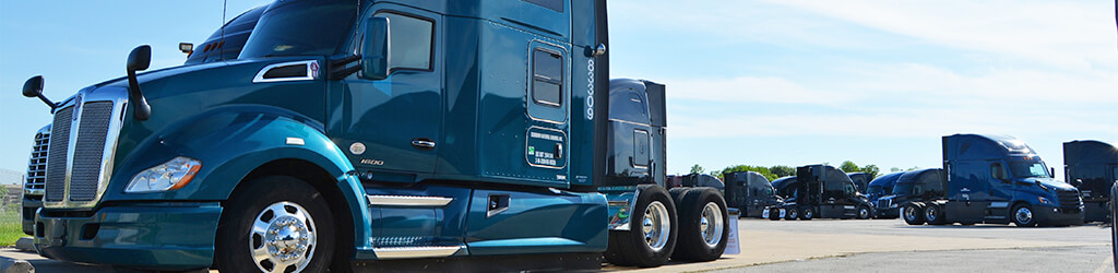 A blue semi-truck parked in a parking lot