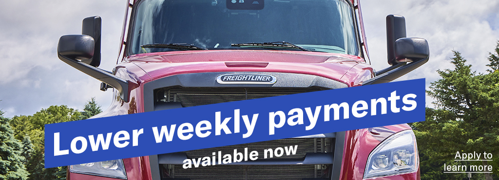 A closeup ground level shot of a red Freightliner Cascadia with the words "Lower weekly payments available now" angled across the grill and a link reading "Apply to learn more" 
