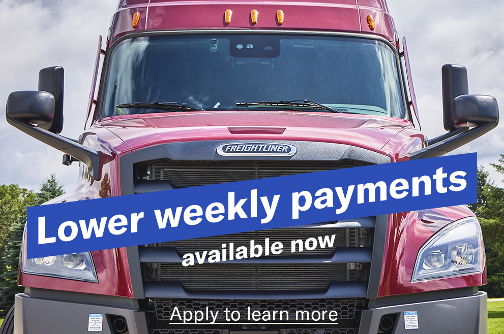 A closeup ground level shot of a red Freightliner Cascadia with the words "Lower weekly payments available now" angled across the grill and a link reading "Apply to learn more" 