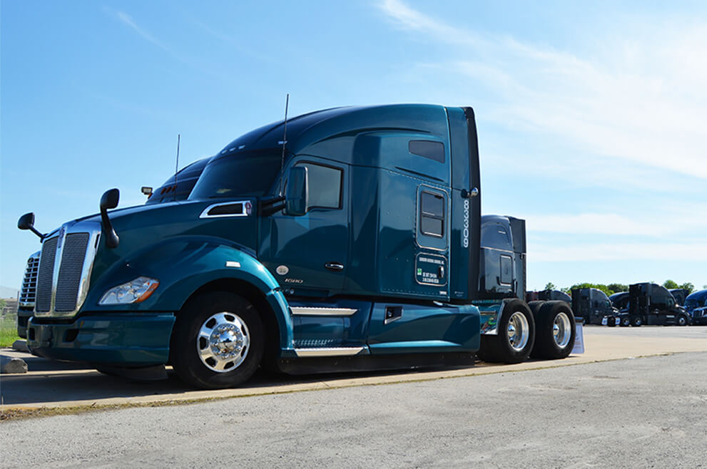 A blue semi-truck parked in a parking lot