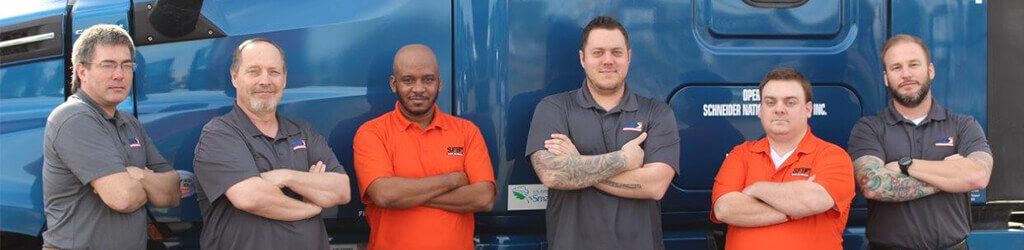 SFI employees and truck drivers stand in front of a semi-truck
