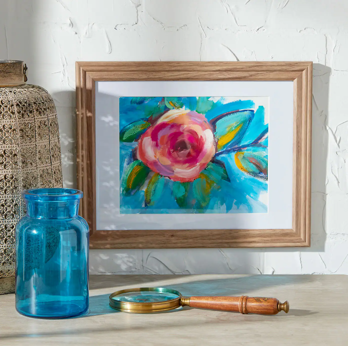 A floral painting in a gold frame