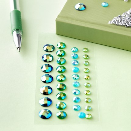 green and blue rhinestone gems on table