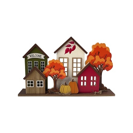 Tabletop decor item with the word "Harvest", with some small houses and trees in orange colors